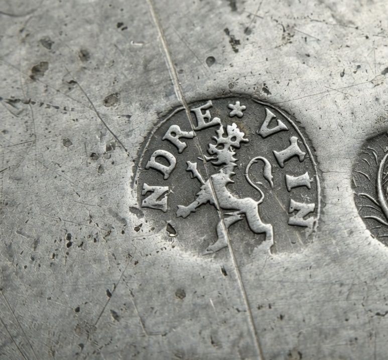 Close crop of the standing-lion ANDRE VTIN touchmark